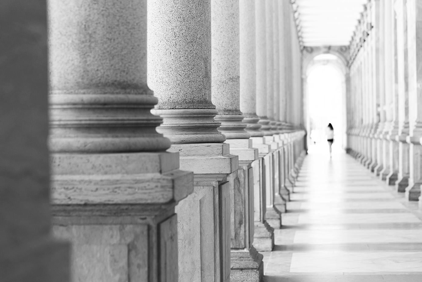 Colonnade, row of classical stone columns, background with copy spaced